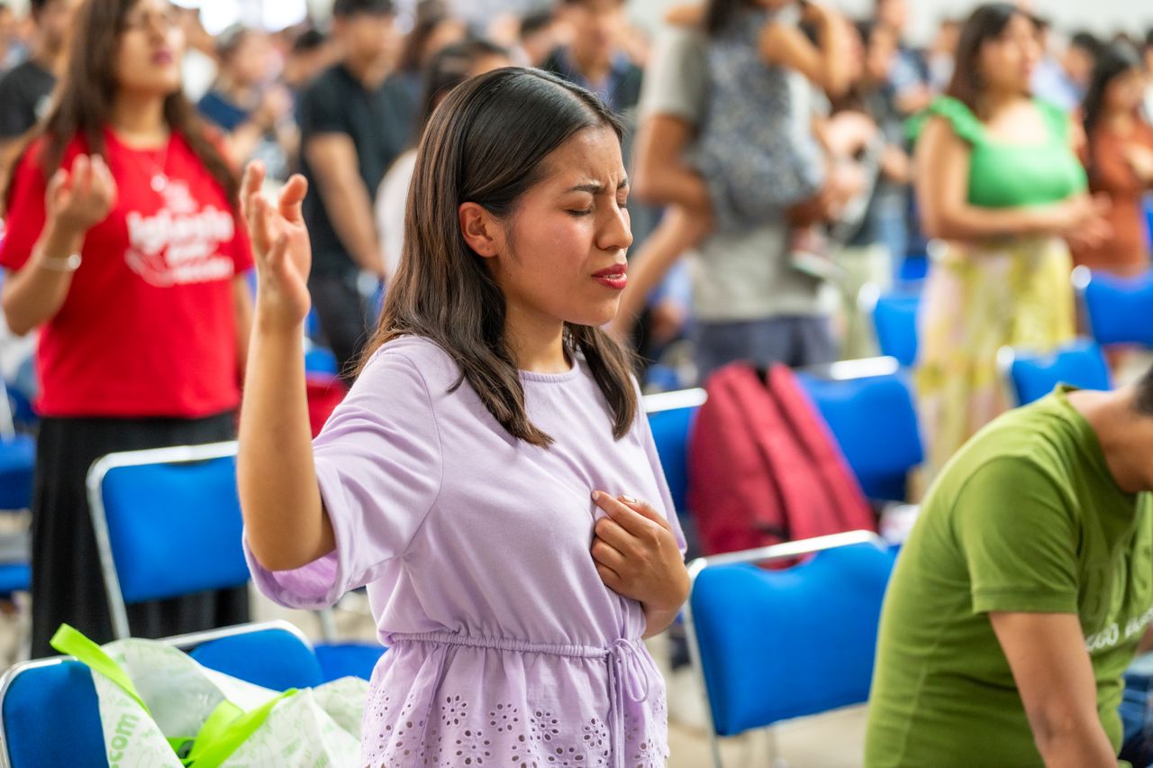 Home A woman immersed in prayer during a church service in Ciudad de México.